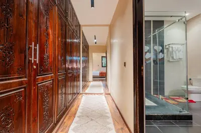a hallway with wooden cabinets and a glass door at Villa Targaït - Luxury villa in Marrakech bliss in Marrakech