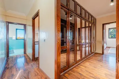 an empty hallway with wood floors and glass doors at Villa Targaït - Luxury villa in Marrakech bliss in Marrakech