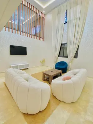 a living room with two white couches and a tv at duplex 3 Rom with spacious Guéliz victor hugo spacieuse in Marrakech