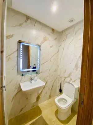 a bathroom with a sink and a toilet and a mirror at duplex 3 Rom with spacious Guéliz victor hugo spacieuse in Marrakech