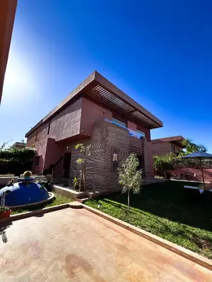a house with a swimming pool in front of it at Villa de luxe, à 20 minutes de Jamaa El Fna in Marrakech