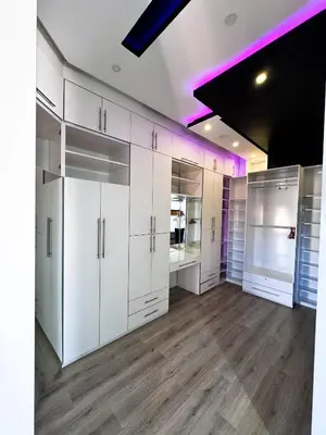 a large room with white cabinets and purple lighting at Villa de luxe, à 20 minutes de Jamaa El Fna in Marrakech