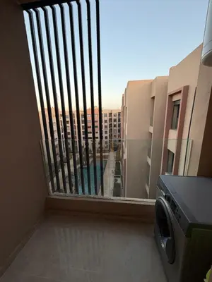 a balcony with a view of a building at Séjour Premium - Piscine, Jacuzzi, Chauffé et Salle de sport in Marrakech