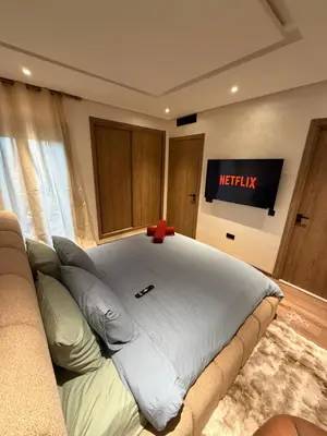 a large bed in a room with a couch at Séjour Premium - Piscine, Jacuzzi, Chauffé et Salle de sport in Marrakech