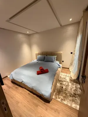a bedroom with a bed with a red ribbon on it at Séjour Premium - Piscine, Jacuzzi, Chauffé et Salle de sport in Marrakech