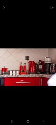 a kitchen with a red stove with pots and pans at Appartemment Luxe Gueliz in Marrakech