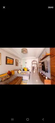 a large living room with a couch and a tv at Appartemment Luxe Gueliz in Marrakech
