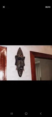 a mask hanging on a wall next to a door at Appartemment Luxe Gueliz in Marrakech