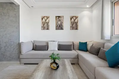 a living room with a couch and a coffee table at Modern apartment, swimming pool and sports in Marrakech