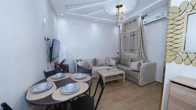 a living room with a table and a couch at Little dream in Marrakech