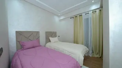 a bedroom with a purple bed and a window at Little dream in Marrakech