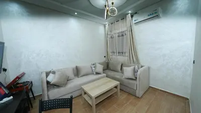 a living room with a couch and a table at Little dream in Marrakech