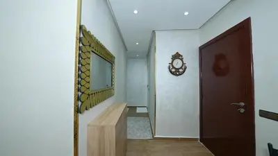 a hallway with a mirror and a wooden table at Little dream in Marrakech