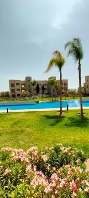 a park with palm trees and a swimming pool at Spacious Ground Floor Oasis with Pool & Golf Course View 1rom in Marrakech