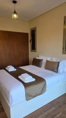 a bedroom with two large beds with towels on them at Spacious Ground Floor Oasis with Pool & Golf Course View 1rom in Marrakech