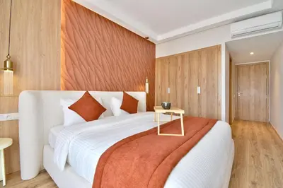 a bedroom with a large white bed and a table at Noria Residence - Premium 2BR Apartment with Pool View in Marrakech