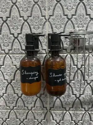 two bottles of honey sitting on a wall at Ryad Lalla khadija in Marrakech