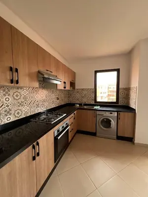 a kitchen with a stove and a washer and dryer at appartement Marrakech in Marrakech