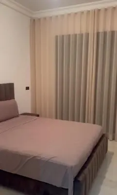 a bedroom with a large bed with curtains at appartement Marrakech in Marrakech
