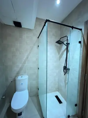a bathroom with a toilet and a glass shower at appartement Marrakech in Marrakech