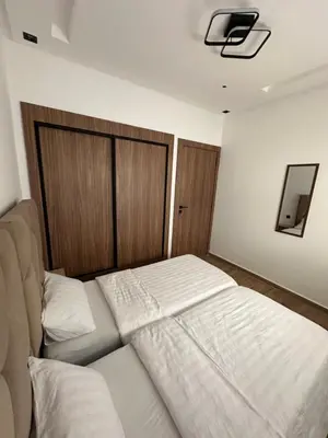 a bedroom with a bed and a tv on the wall at Appartement cosy à Marrakech in Marrakech