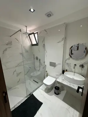 a bathroom with a shower and a toilet and a sink at Appartement cosy à Marrakech in Marrakech