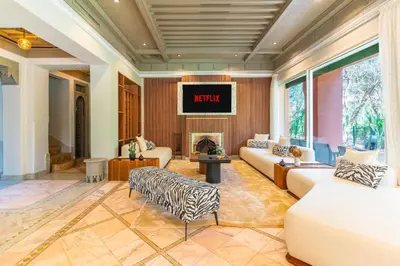 a living room with two couches and a fireplace at Luxurious villa Marrakech La Palmeraie in Marrakech
