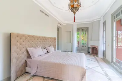 a bedroom with a large bed and a ceiling at Luxurious villa Marrakech La Palmeraie in Marrakech