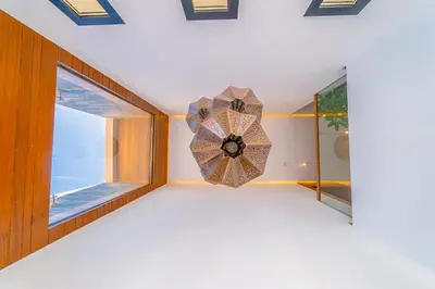a room with a clock on the wall and a window at Villa Lumeria in Marrakech