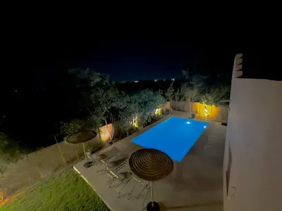an overhead view of a swimming pool at night at Charmante villa avec piscine privée et jardin in Marrakech