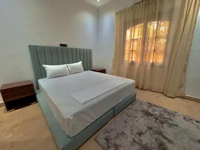 a bedroom with a large bed and a window at Charmante villa avec piscine privée et jardin in Marrakech