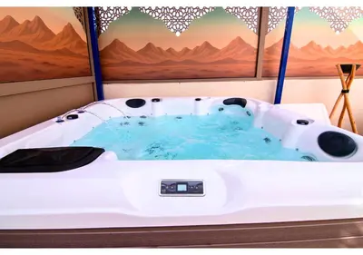 a white bath tub in a room with a painting at Luxury Riad Marrakech - 3BR - Rooftop - Jacuzzi in Marrakech