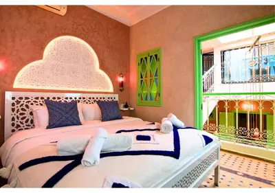 a bedroom with a large bed and a window at Luxury Riad Marrakech - 3BR - Rooftop - Jacuzzi in Marrakech