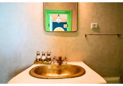 a bathroom with a sink and a picture on the wall at Luxury Riad Marrakech - 3BR - Rooftop - Jacuzzi in Marrakech