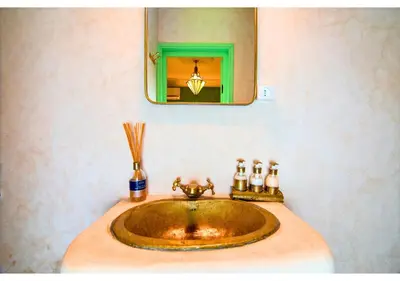 a sink in a bathroom with a mirror at Luxury Riad Marrakech - 3BR - Rooftop - Jacuzzi in Marrakech