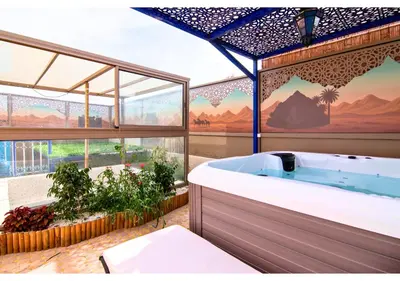 a bathroom with a tub with a view of mountains at Luxury Riad Marrakech - 3BR - Rooftop - Jacuzzi in Marrakech