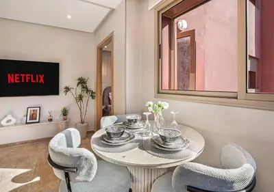 a dining room with a table and chairs at Appartement Chic & Neuf à Guéliz - Terrasse et Parking in Marrakech