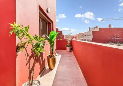 a balcony with plants on the side of a building at Appartement Chic & Neuf à Guéliz - Terrasse et Parking in Marrakech