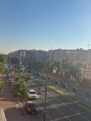 a city street with cars parked in a parking lot at Refined Apartment in Guéliz Laya Home Luxury in Marrakech