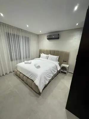 a bedroom with a large bed with white sheets at Refined Apartment in Guéliz Laya Home Luxury in Marrakech