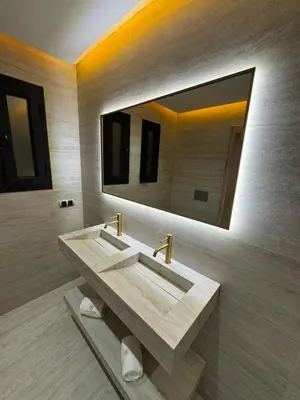 a bathroom with a sink and a large mirror at Refined Apartment in Guéliz Laya Home Luxury in Marrakech