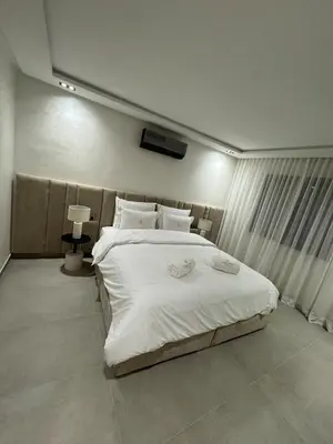 a bedroom with a large bed with white sheets and pillows at Refined Apartment in Guéliz Laya Home Luxury in Marrakech