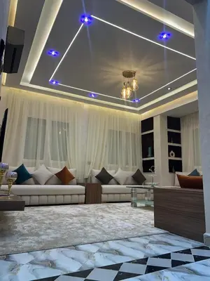 a large living room with couches at Appartement Abdessamad Hébergement réservé aux familles in El Gouassem
