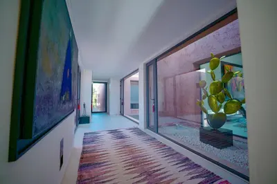 a hallway with paintings on the walls and a room with a hallway at Royal Palm Luxury Villa Heated Pool Spa in Moussiha