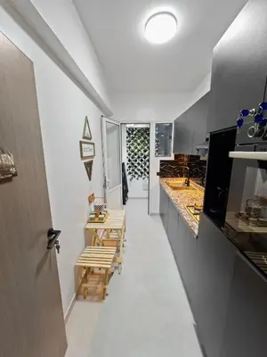 a hallway of a kitchen with wooden benches at Cozy Apt Close to Gueliz & Medina in Marrakech