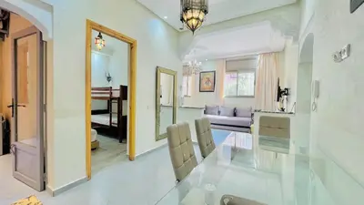a living room with a glass table and a living room at Cycas family apart ground floor parking in Marrakech