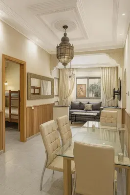 a living room with a couch and a table at Cycas family apart ground floor parking in Marrakech