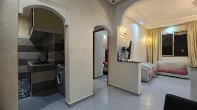 a room with a kitchen and a living room at Cycas Family Apart grand wifi parking in Marrakech