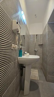a bathroom with a sink and a shower at Cycas Family Apart grand wifi parking in Marrakech
