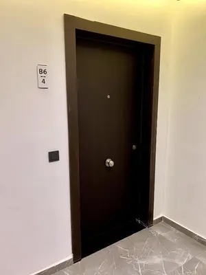 a brown door in the corner of a room at Palmeraie Gates 2 chambres Piscine et Parking in Marrakech
